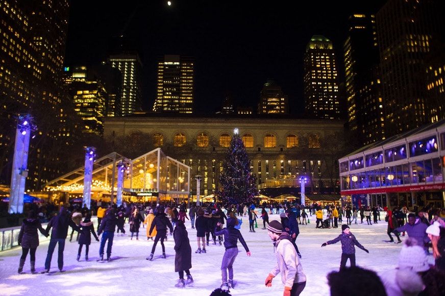 People ice skating at a skating rink.